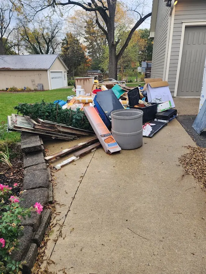 Dumpster being loaded with debris for Commercial Dumpster Rental in Pittsboro